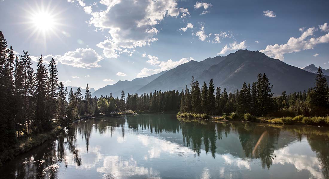 cover   Sun shining over a pristine alpine lake