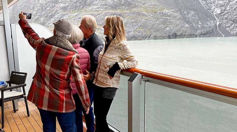 Four people on cruise ship deck taking a selfie