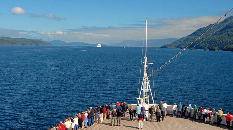 Crowd on ship deck enjoying ocean view