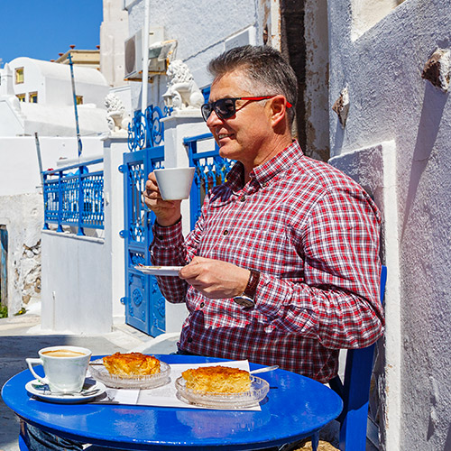 Man Enjoying Coffee in Santorini Greece