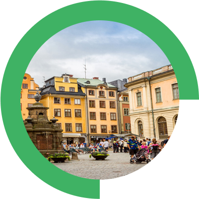 A group of people walking around a city square.